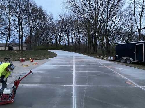 Fresh concrete slab divided into clean sections beside Cabrera Concrete's trailer.
